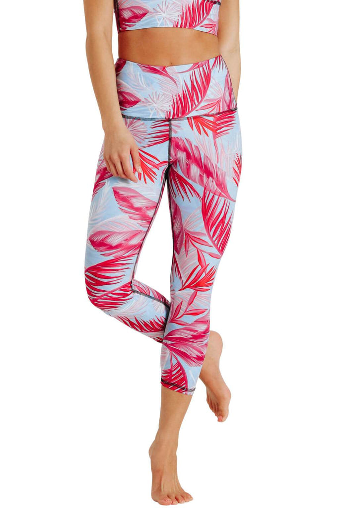 Yoga Democracy Women's Eco-friendly yoga capris crop leggings in Hot Tropic flamingo pink and blue print. USA made from post-consumer recycled plastic bottles. Sweat wicking, anti-microbial, and quick dry ultra-soft brushed fabric.